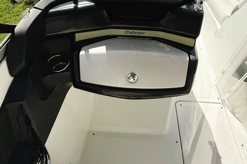 Slide: The Image of 2010 Seadoo 210 Challenger SE boat interior with storage compartment and cup holder. - 15