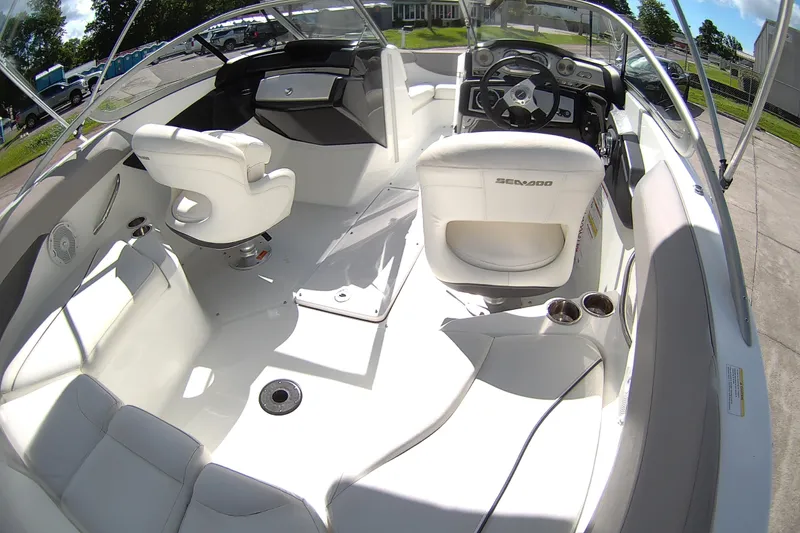 Slide: The Image of 2010 Seadoo 210 Challenger SE boat interior with white seating and steering console. - 16