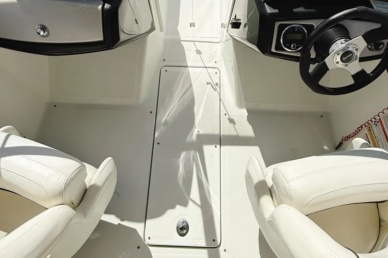 Slide: The Image of 2010 Seadoo 210 Challenger SE interior with white seats and steering wheel. - 18
