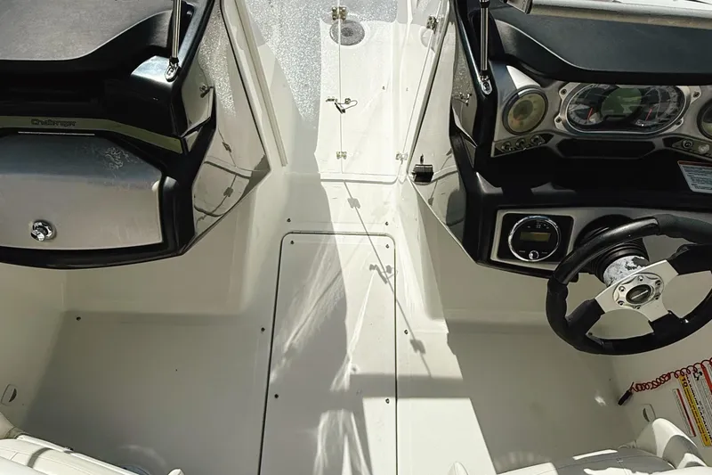Slide: The Image of 2010 Seadoo 210 Challenger SE cockpit with steering wheel and dashboard controls. - 19