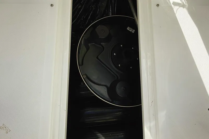 Slide: The Image of 2010 Seadoo 210 Challenger SE storage compartment with black circular cover. - 25