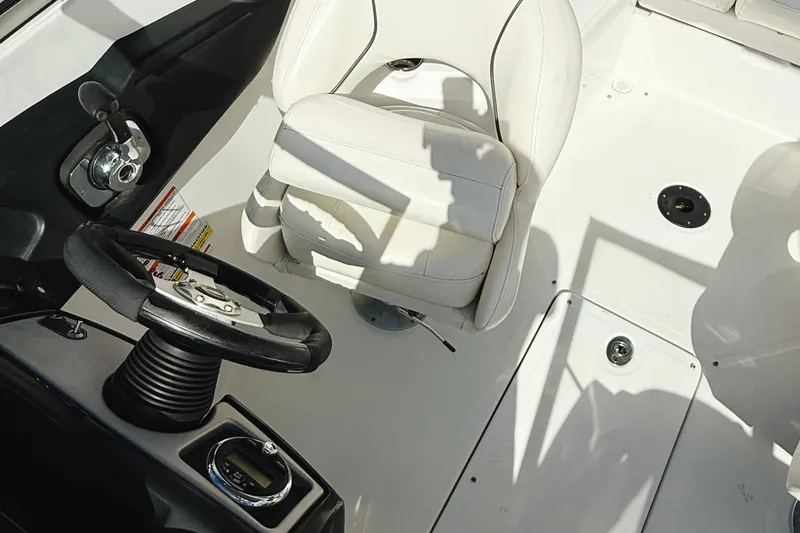 Slide: The Image of 2010 Seadoo 210 Challenger SE cockpit with steering wheel and white captain's chair. - 8