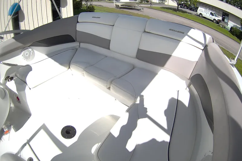 Slide: The Image of 2010 Seadoo 210 Challenger SE boat interior with white and gray seating. - 9