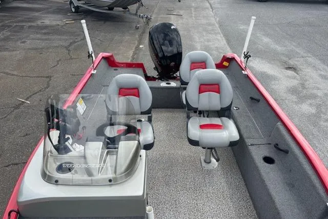 Slide: The Image of 2016 Tracker Pro Guide V-16 SC fishing boat with seating and motor, parked on pavement. - 10
