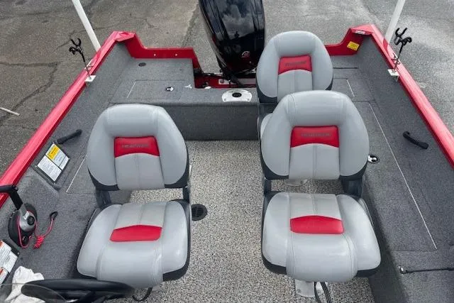 Slide: The Image of 2016 Tracker Pro Guide V-16 SC boat interior with four gray and red seats. - 11