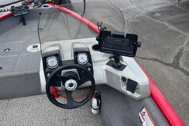 Slide: The Image of 2016 Tracker Pro Guide V-16 SC boat dashboard with steering wheel and gauges. - 12