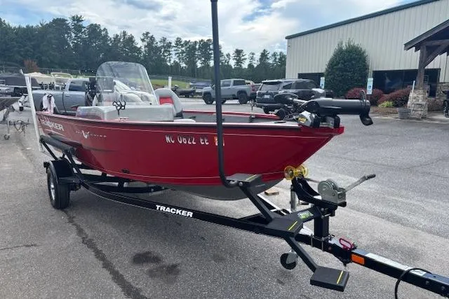 Slide: The Image of 2016 Tracker Pro Guide V-16 SC boat on trailer in parking lot. - 13