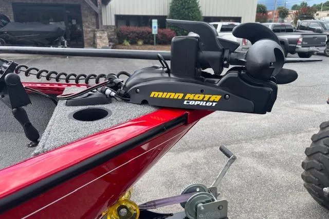 Slide: The Image of Red 2016 Tracker Pro Guide V-16 SC boat with Minn Kota CoPilot trolling motor. - 14