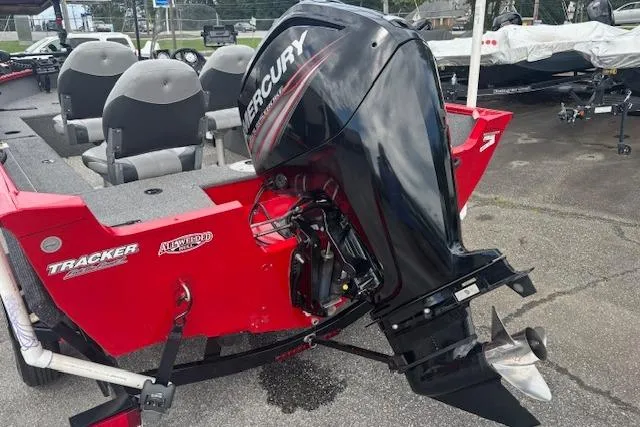 Slide: The Image of 2016 Tracker Pro Guide V-16 SC boat with Mercury outboard motor, red exterior. - 4