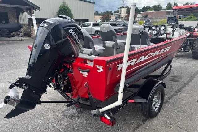Slide: The Image of 2016 Tracker Pro Guide V-16 SC boat with Mercury engine, red exterior, parked on trailer. - 6