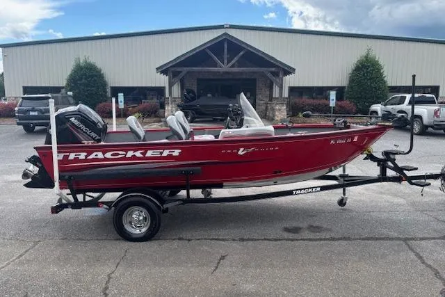 Slide: The Image of 2016 Tracker Pro Guide V-16 SC boat on trailer, parked outside a building. - 7
