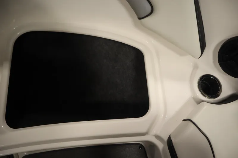 Slide: The Image of 2018 Yamaha AR195 boat interior with cup holder and storage compartment. - 15