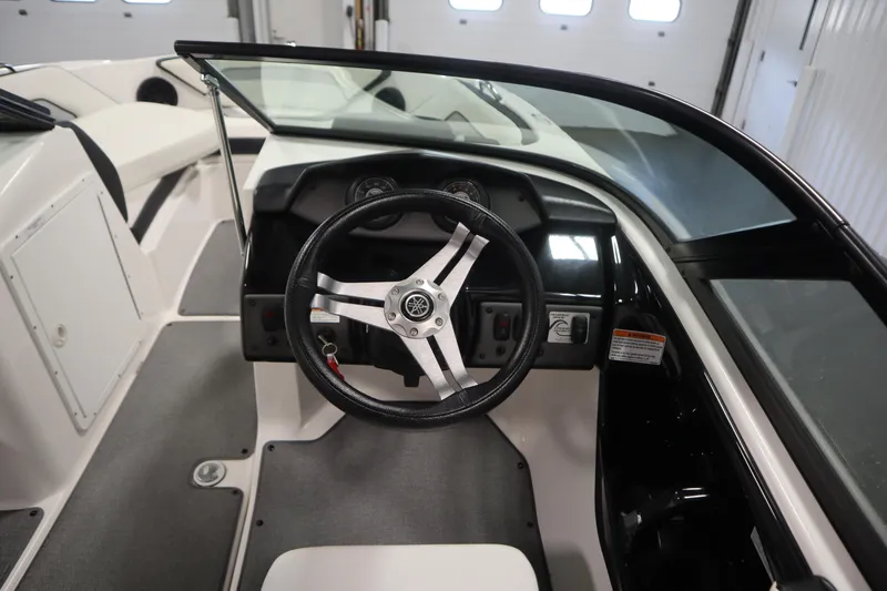 Slide: The Image of 2018 Yamaha AR195 boat cockpit with steering wheel and dashboard controls. - 19