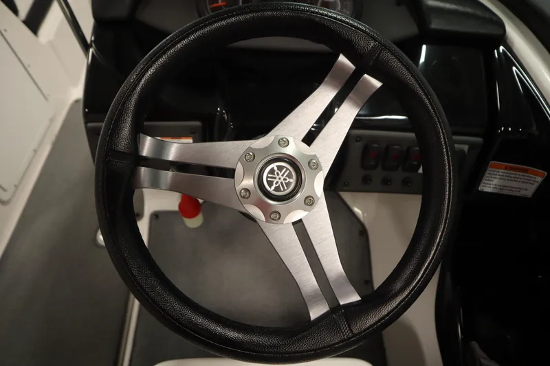 Slide: The Image of Steering wheel of 2018 Yamaha Boats AR195, featuring sleek design and logo. - 20