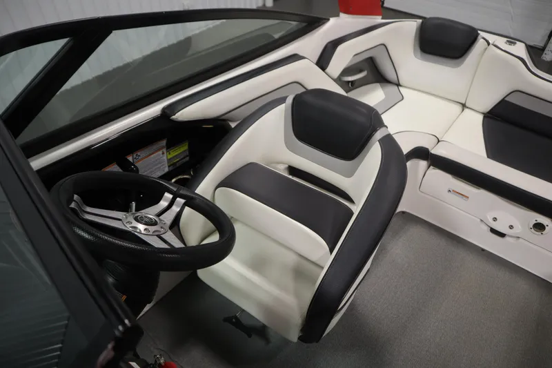 Slide: The Image of 2018 Yamaha AR195 boat interior with sleek black and white seating and steering wheel. - 27