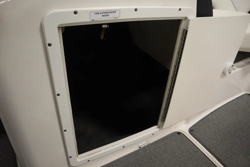 Slide: The Image of Open storage compartment on 2018 Yamaha AR195 boat, labeled for fire extinguisher storage. - 31