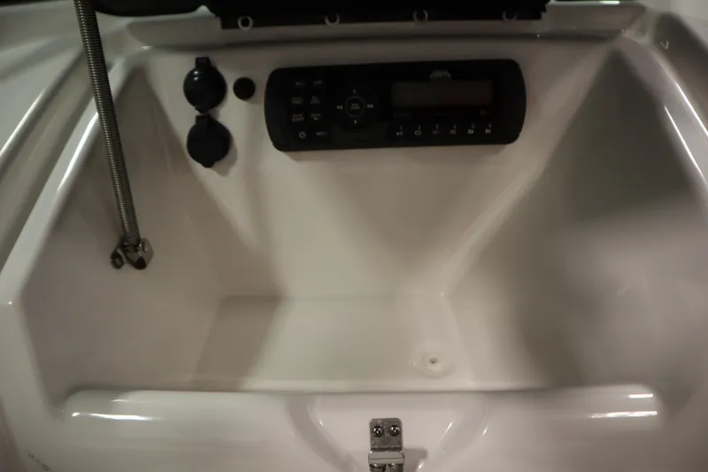 Slide: The Image of Control panel of a 2018 Yamaha Boats AR195, featuring audio and power outlets. - 33