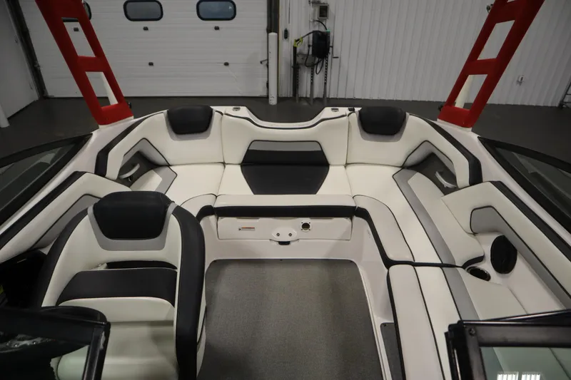 Slide: The Image of 2018 Yamaha AR195 boat interior with white and black seating, red accents, and spacious layout. - 35