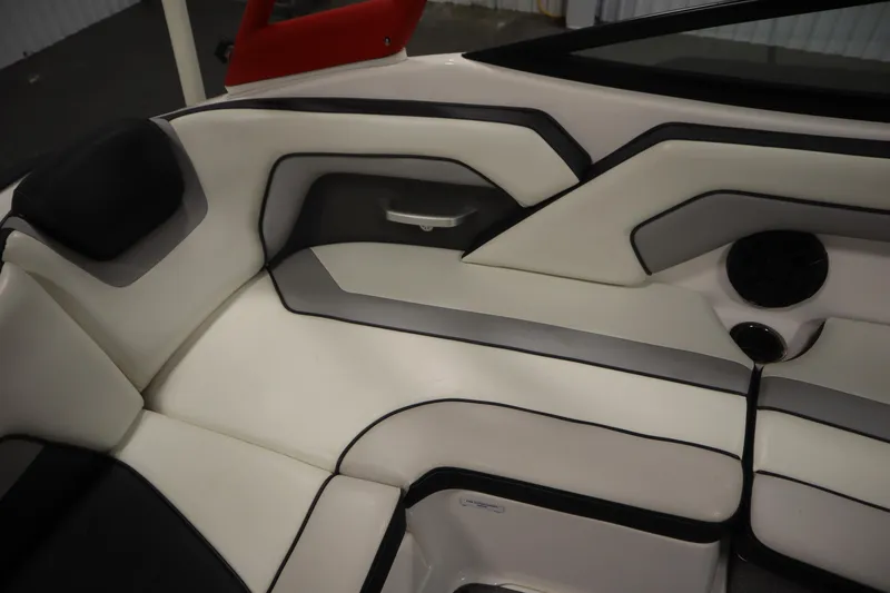 Slide: The Image of 2018 Yamaha Boats AR195 interior seating with white and gray upholstery. - 36