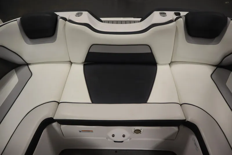 Slide: The Image of 2018 Yamaha Boats AR195 interior seating, featuring sleek black and white upholstery design. - 38