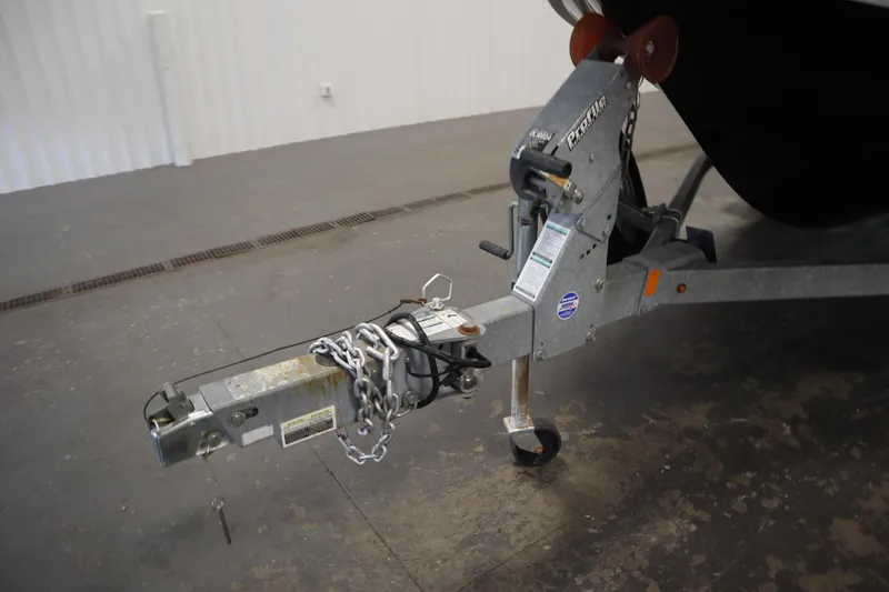 Slide: The Image of Trailer hitch of a 2018 Yamaha Boats AR195, secured with chains in a garage. - 48