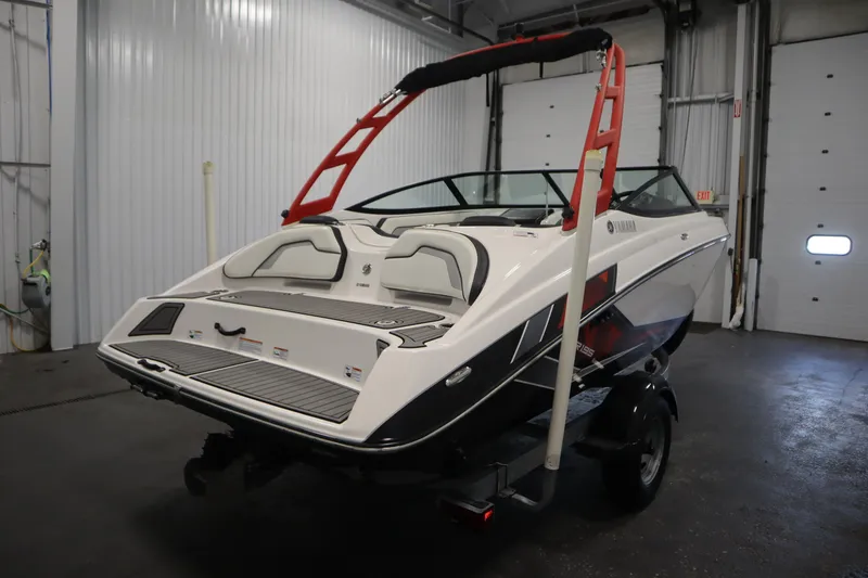 Slide: The Image of 2018 Yamaha AR195 boat in a garage, featuring sleek design and red accents. - 5