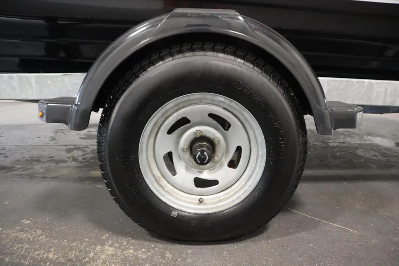 Slide: The Image of 2018 Yamaha 195 AR trailer wheel with black tire and metal rim. - 51