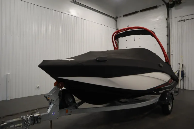 Slide: The Image of 2018 Yamaha 195 AR boat with cover on trailer in indoor storage. - 52