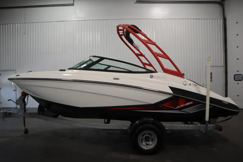 Slide: The Image of 2018 Yamaha AR195 boat with red tower on trailer in indoor setting. - 8