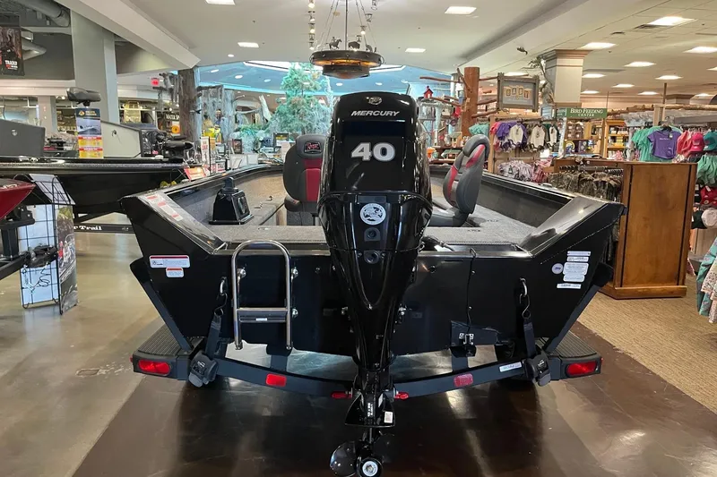 Slide: The Image of 2024 Ranger VS1665T boat with Mercury 40 engine displayed indoors. - 5