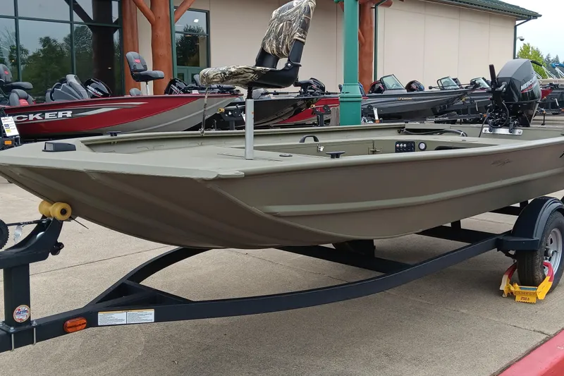 The Image of 2026 Tracker Grizzly 1654 T Sportsman boat on trailer, displayed outdoors. - 0