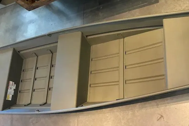 The Image of 2026 Tracker Grizzly 14 Jon boat interior, showcasing seating and storage layout. - 0