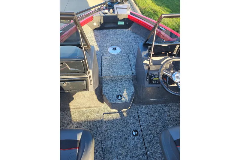 Slide: The Image of 2026 Tracker Targa V-18 WT boat interior with steering wheel and carpeted flooring. - 2