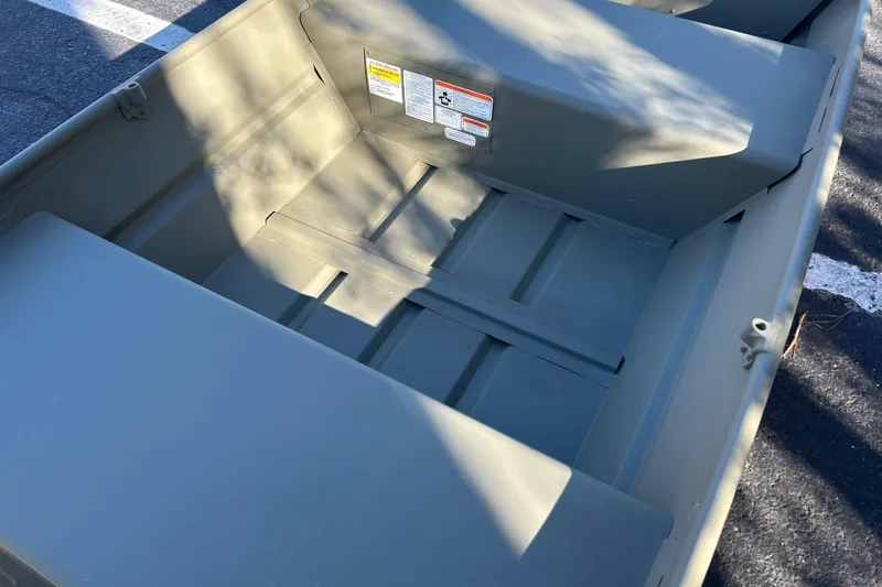 Slide: The Image of 2026 Tracker Grizzly 12 Jon boat interior, showing seating and storage areas. - 7