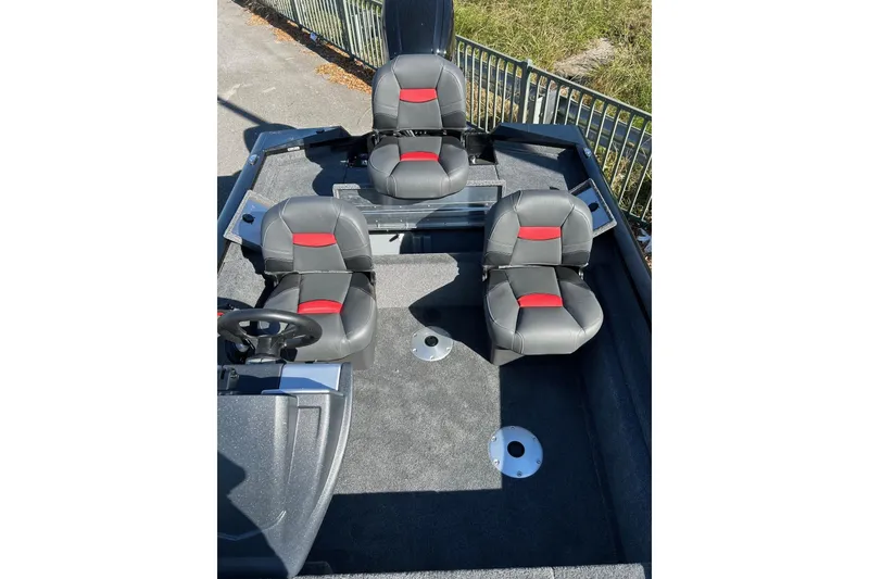 Slide: The Image of 2026 Tracker Pro Team 175 Crappie Edition boat interior with three black and red seats. - 3