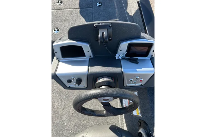 Slide: The Image of 2026 Tracker Pro Team 175 Crappie Edition boat dashboard with steering wheel and controls. - 4