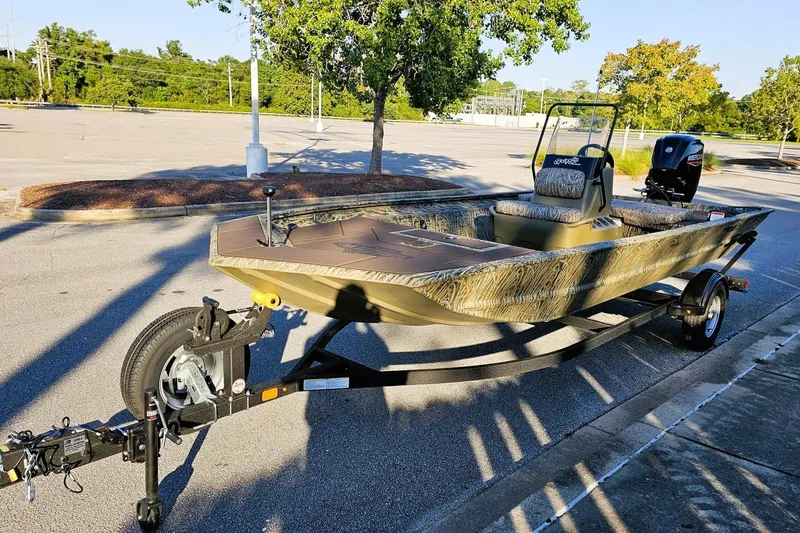 Slide: The Image of 2026 Tracker Grizzly 1860 CC boat on trailer in parking lot, sunny day. - 7