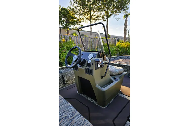 Slide: The Image of 2026 Tracker Grizzly 1860 CC boat console with steering wheel and controls. - 8