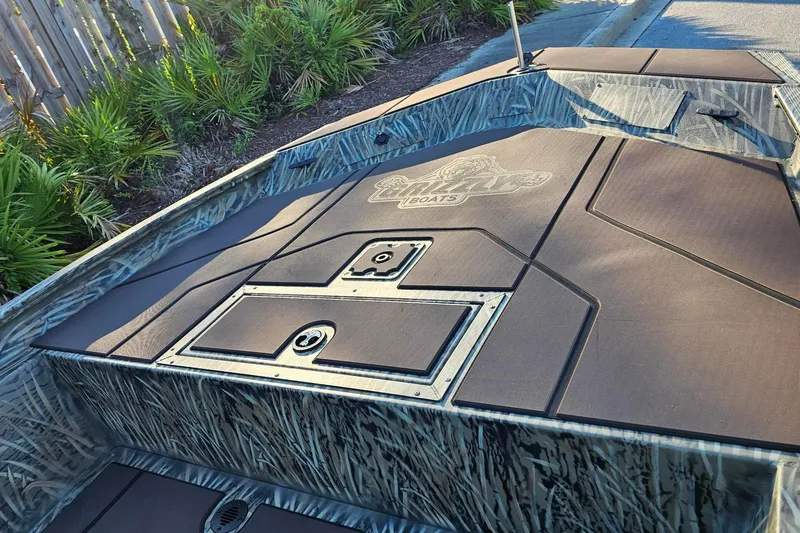 Slide: The Image of 2026 Tracker Grizzly 1860 CC boat with camo design and storage compartments. - 9