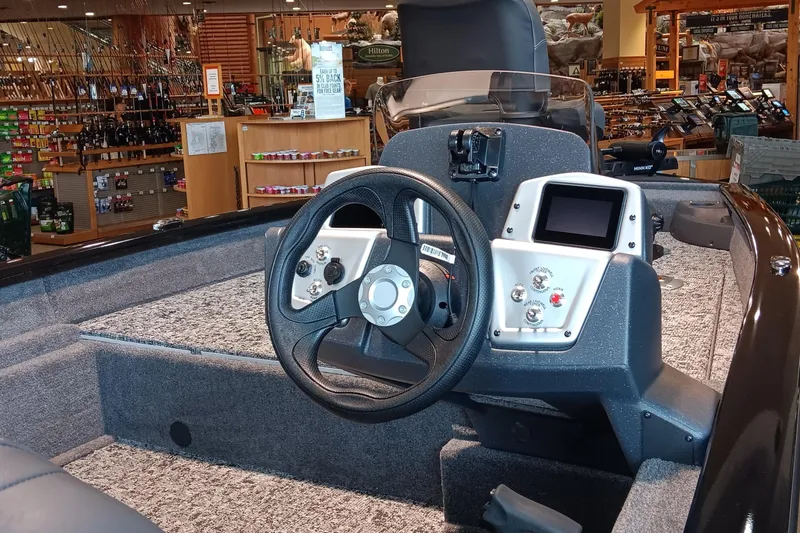 Slide: The Image of 2026 Tracker Pro Team 175 Crappie Edition boat dashboard in a showroom setting. - 4