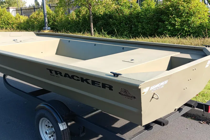 Slide: The Image of 2026 Tracker Grizzly 1648 Utility boat on trailer, parked outdoors. - 3