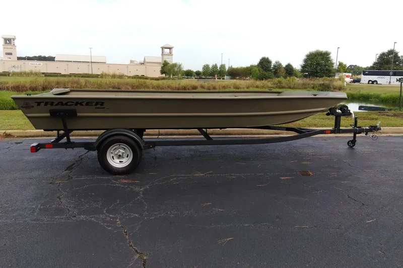 The Image of 2026 Tracker Grizzly 1860 Utility boat on trailer, parked outdoors. - 0