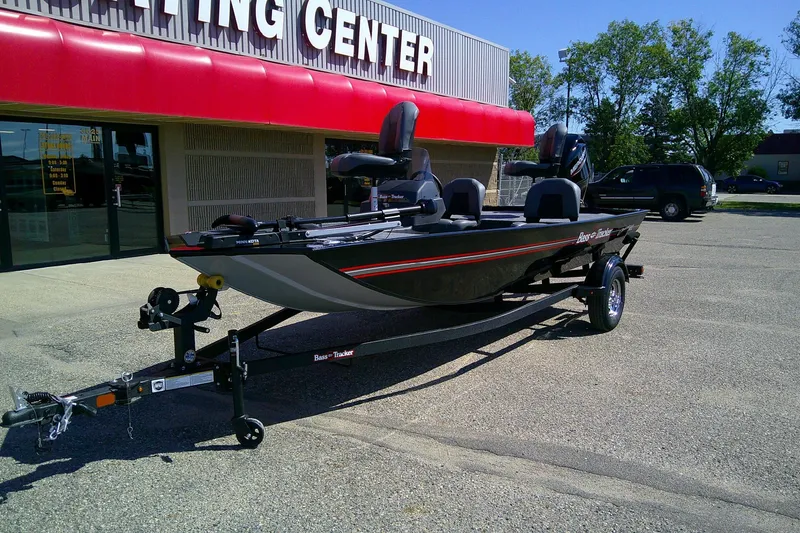 Slide: The Image of 2026 Tracker Bass Tracker Classic XL boat on trailer outside a sporting center. - 61