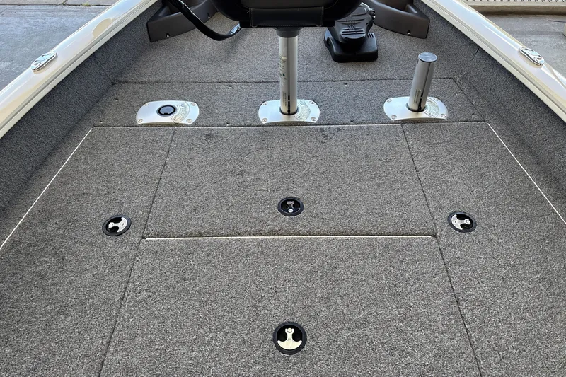 Slide: The Image of 2025 Tracker Pro Team 175 Crappie Edition boat interior with gray carpeted deck. - 19