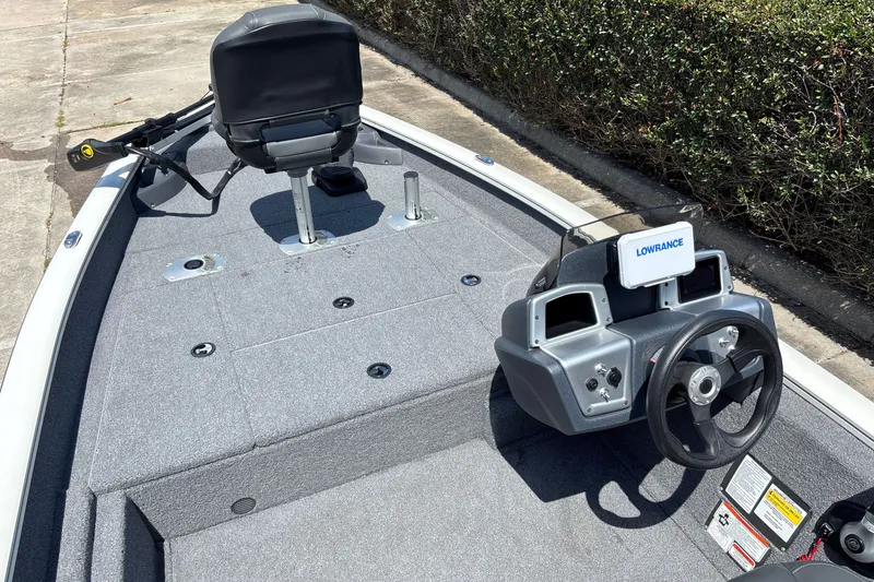 Slide: The Image of 2025 Tracker Pro Team 175 Crappie Edition boat interior with steering console and seating. - 13