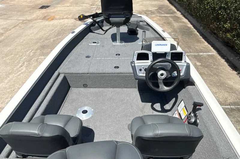 Slide: The Image of 2025 Tracker Pro Team 175 Crappie Edition boat interior with steering console and seating. - 14