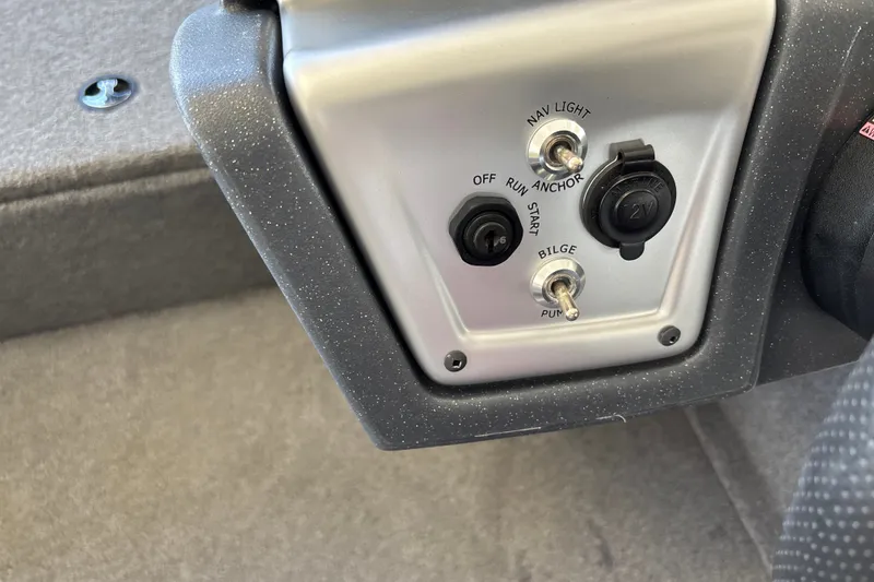 Slide: The Image of Control panel of 2025 Tracker Pro Team 175 Crappie Edition boat with switches and 12V outlet. - 21