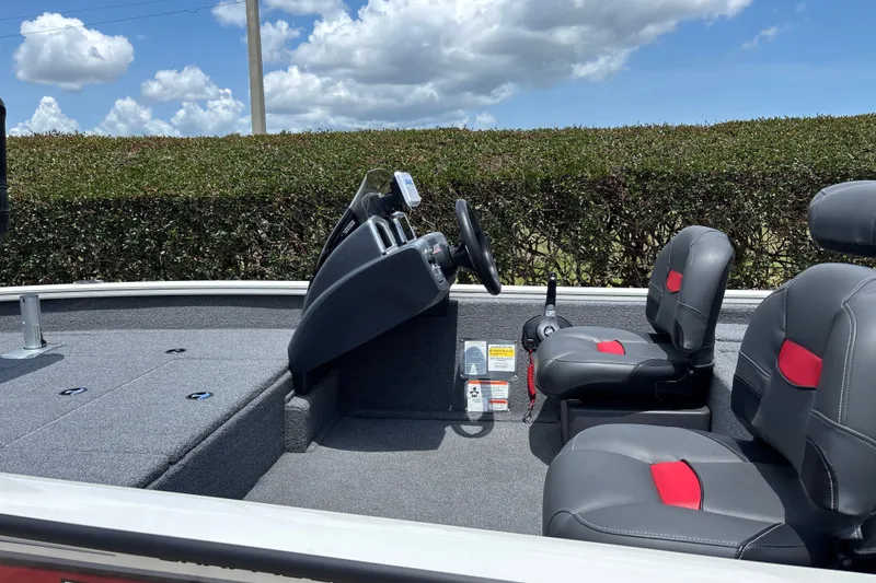 Slide: The Image of 2025 Tracker Pro Team 175 Crappie Edition boat interior with gray and red seating. - 16