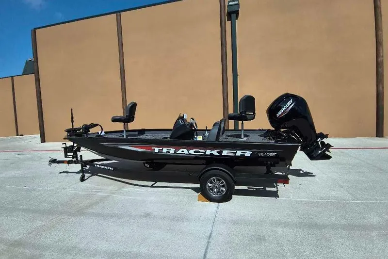 Slide: The Image of 2026 Tracker Pro Team 190 boat on trailer, parked outdoors under blue sky. - 3