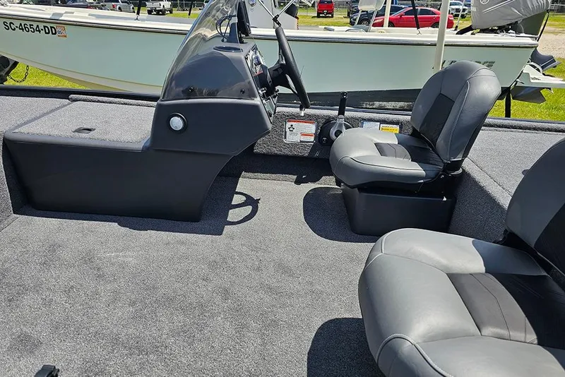 Slide: The Image of 2026 Tracker Bass Tracker Classic XL interior with gray seating and steering console. - 10